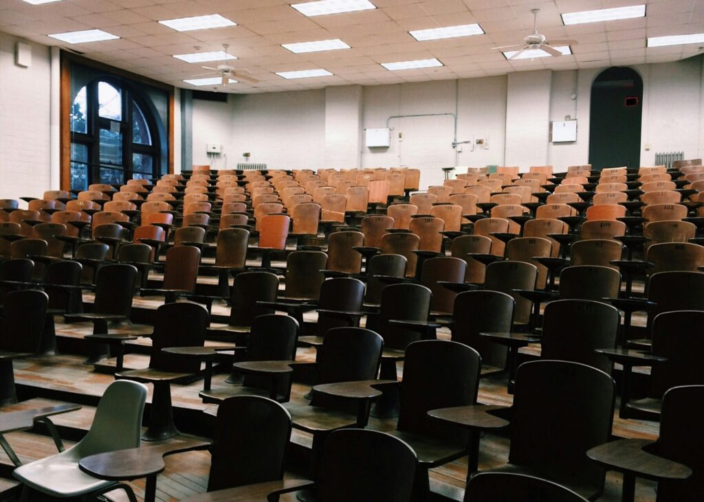 Empty University lecture hall full of chairs.